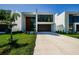 Modern home featuring a large garage, striking wood door, and minimalist design at 88 Avonwood, Tampa, FL 33625