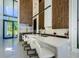 Modern kitchen with an island, stainless refrigerator, floor to ceiling wood paneling, and lots of light at 88 Avonwood, Tampa, FL 33625