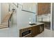 Modern kitchen with stainless appliances, wooden cabinets, island, and view of staircase at 88 Avonwood, Tampa, FL 33625