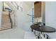 Modern kitchen with an island and seating, stainless appliances, and view of staircase at 88 Avonwood, Tampa, FL 33625