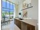 Modern kitchen and living room featuring an open floor plan and floor-to-ceiling windows at 88 Avonwood, Tampa, FL 33625