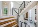 Modern staircase featuring wood steps and metal railing at 88 Avonwood, Tampa, FL 33625