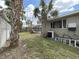 A well-sized backyard with a screened pool area and mature palm trees, providing a tranquil outdoor escape at 101 Gulf Blvd, Belleair Beach, FL 33786