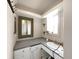Bathroom with a unique mirror frame, single sink and neutral colors at 101 Gulf Blvd, Belleair Beach, FL 33786