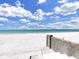 Steps lead to a beautiful white sand beach with calm turquoise water at 101 Gulf Blvd, Belleair Beach, FL 33786
