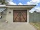 Unique garage door with decorative details, adding character to the home's exterior at 101 Gulf Blvd, Belleair Beach, FL 33786
