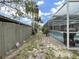 Backyard featuring a screened pool area and a lush green lawn at 101 Gulf Blvd, Belleair Beach, FL 33786
