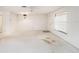 Bright and airy living room with a large window, neutral walls, and classic light fixture at 110 Hammock Pine Blvd # 110, Clearwater, FL 33761