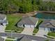 Aerial shot showcasing the property's location among lush greenery and a tranquil pond at 11465 June Briar Loop, San Antonio, FL 33576