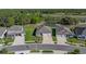 An aerial view of the property showcasing its location next to a pond and green surroundings at 11465 June Briar Loop, San Antonio, FL 33576