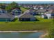 Aerial view of back of home showing pond view and ample green space at 11465 June Briar Loop, San Antonio, FL 33576