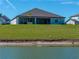 Back of home has a screened lanai and looks out to the lawn and pond at 11465 June Briar Loop, San Antonio, FL 33576