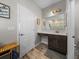 Bathroom featuring a single sink vanity, marble countertop, wood-look tile, and access to the shower at 11465 June Briar Loop, San Antonio, FL 33576