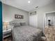 Bedroom with wood-look floors, a closet, and a side table with a lamp at 11465 June Briar Loop, San Antonio, FL 33576