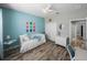 Inviting bedroom featuring a white daybed with blue accents, complemented by a closet and dresser at 11465 June Briar Loop, San Antonio, FL 33576