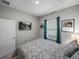 Bedroom featuring wood-look floors, and a wall-mounted television at 11465 June Briar Loop, San Antonio, FL 33576