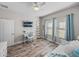 Bright bedroom with light walls, includes ceiling fan, and a functional workspace with a floating shelf at 11465 June Briar Loop, San Antonio, FL 33576