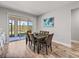 Bright dining room with access to the patio, a modern table, and decorative artwork at 11465 June Briar Loop, San Antonio, FL 33576