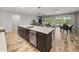 Spacious kitchen island with stainless steel dishwasher connects to dining and living areas at 11465 June Briar Loop, San Antonio, FL 33576