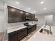 Modern kitchen with stainless steel appliances, ample countertop space, and dark wood cabinetry at 11465 June Briar Loop, San Antonio, FL 33576