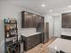 Kitchen area displays modern stainless steel appliances and dark wood cabinets with plenty of storage at 11465 June Briar Loop, San Antonio, FL 33576