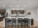 Bright, modern kitchen featuring a large island with seating and recessed lighting for a warm ambiance at 11465 June Briar Loop, San Antonio, FL 33576