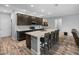 Well-lit kitchen boasts a spacious island with breakfast bar, stainless appliances, and ample counter space at 11465 June Briar Loop, San Antonio, FL 33576