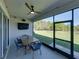 View of screened lanai with ceiling fan and outdoor dining set at 11465 June Briar Loop, San Antonio, FL 33576