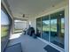 View of the covered lanai with ceiling fan and a sliding glass door to the interior at 11465 June Briar Loop, San Antonio, FL 33576