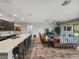Bright and airy living space showcases a large kitchen island open to the Gathering room with sliding glass doors at 11465 June Briar Loop, San Antonio, FL 33576