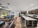 Open concept living features a kitchen island with bar seating and flows into the living and dining areas at 11465 June Briar Loop, San Antonio, FL 33576