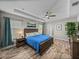 Inviting main bedroom featuring a tray ceiling, tile floors, and ample natural light at 11465 June Briar Loop, San Antonio, FL 33576