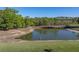 Scenic pond view with wooden bridge and natural surroundings, perfect for a tranquil community setting at 11465 June Briar Loop, San Antonio, FL 33576
