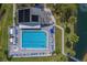 Aerial view of the pool and sun deck surrounded by palm trees, next to a walkway to the water at 11590 Shipwatch Dr # 342, Largo, FL 33774