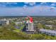 A waterfront condo complex surrounded by lush greenery and a tranquil lake at 11590 Shipwatch Dr # 342, Largo, FL 33774