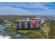 A waterfront condo building nestled in a serene community with lush greenery and a tranquil lake at 11590 Shipwatch Dr # 342, Largo, FL 33774
