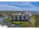 A waterfront condo building nestled in a serene community with lush greenery and a tranquil lake at 11590 Shipwatch Dr # 342, Largo, FL 33774