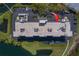 Aerial view of the building's roof with a parking lot, nearby pond, and well-maintained green spaces at 11590 Shipwatch Dr # 342, Largo, FL 33774
