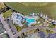 Aerial view of a community pool, waterfront, boat docks, and tennis courts at 11590 Shipwatch Dr # 342, Largo, FL 33774