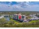 A waterfront condo complex surrounded by lush greenery and a tranquil lake at 11590 Shipwatch Dr # 342, Largo, FL 33774