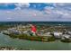 A serene aerial view of a waterfront condominium complex with lush landscaping and stunning water views at 11590 Shipwatch Dr # 342, Largo, FL 33774