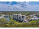 A waterfront condo complex surrounded by lush greenery and a tranquil lake at 11590 Shipwatch Dr # 342, Largo, FL 33774
