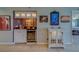 Home wet bar area with wine storage and art at 11590 Shipwatch Dr # 342, Largo, FL 33774