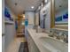 Dual sink bathroom with marble counter tops, a walk-in shower, and blue walls for a spa-like feel at 11590 Shipwatch Dr # 342, Largo, FL 33774