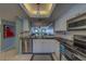 This kitchen has all white cabinets, black countertops and stainless steel appliances at 11590 Shipwatch Dr # 342, Largo, FL 33774