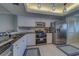 This kitchen boasts stainless steel appliances, white cabinets, black countertops and updated lighting at 11590 Shipwatch Dr # 342, Largo, FL 33774