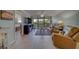 This living room showcases tile floors, furniture, decor and access to the balcony at 11590 Shipwatch Dr # 342, Largo, FL 33774