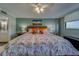The main bedroom features a queen sized bed with plush pillows, a window, and an en suite bathroom at 11590 Shipwatch Dr # 342, Largo, FL 33774