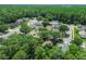 An aerial view showcasing the homes nestled in a lush, green, tree-filled neighborhood in the community at 1187 Mistwood Dr, Tarpon Springs, FL 34688