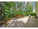 Brick paved backyard provides a tranquil setting with lush landscaping and ample space for outdoor activities at 1187 Mistwood Dr, Tarpon Springs, FL 34688
